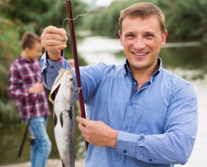 Man holding fish after fishing